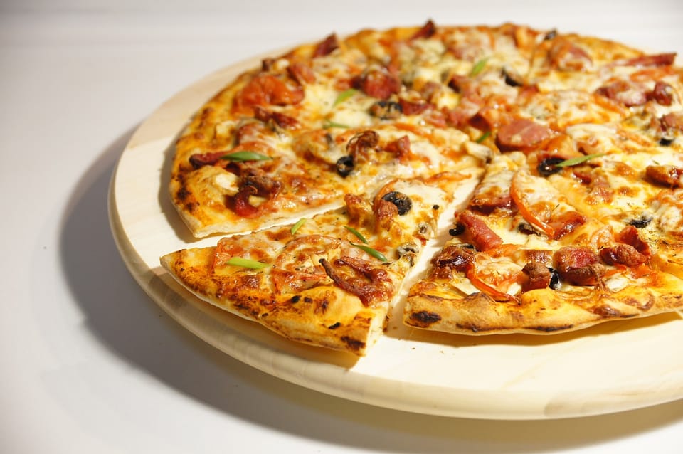 Donair Beef pizza sliced on a board