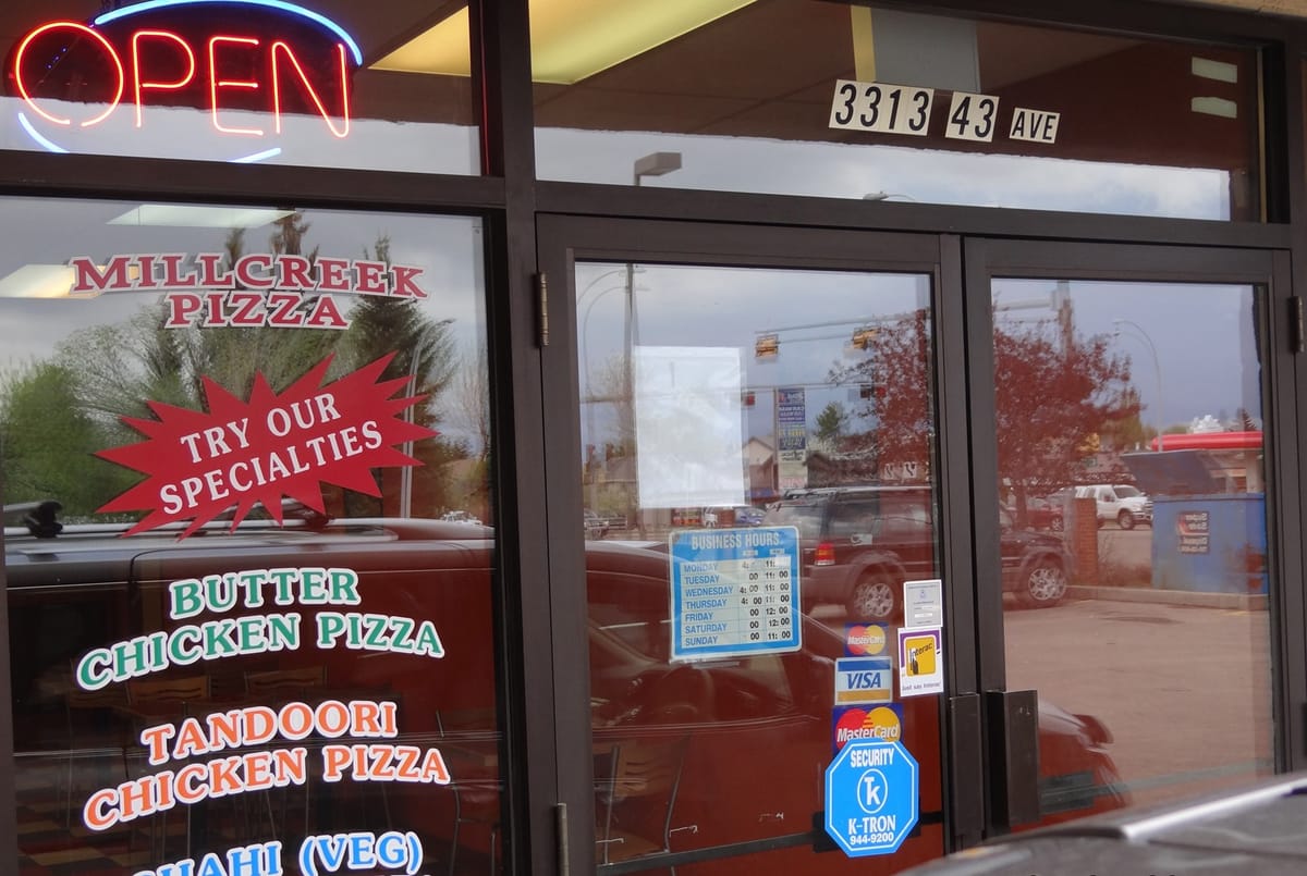 The Millcreek Pizza storefront on 43 Avenue in Millwoods